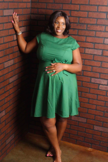 A reviewer wearing the knee-length, short-sleeve, A-line dress in green