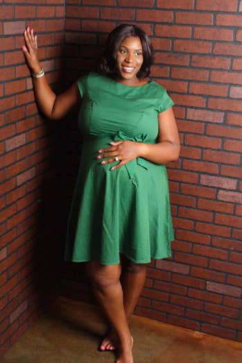 A reviewer wearing the knee-length, short-sleeve, A-line dress in green