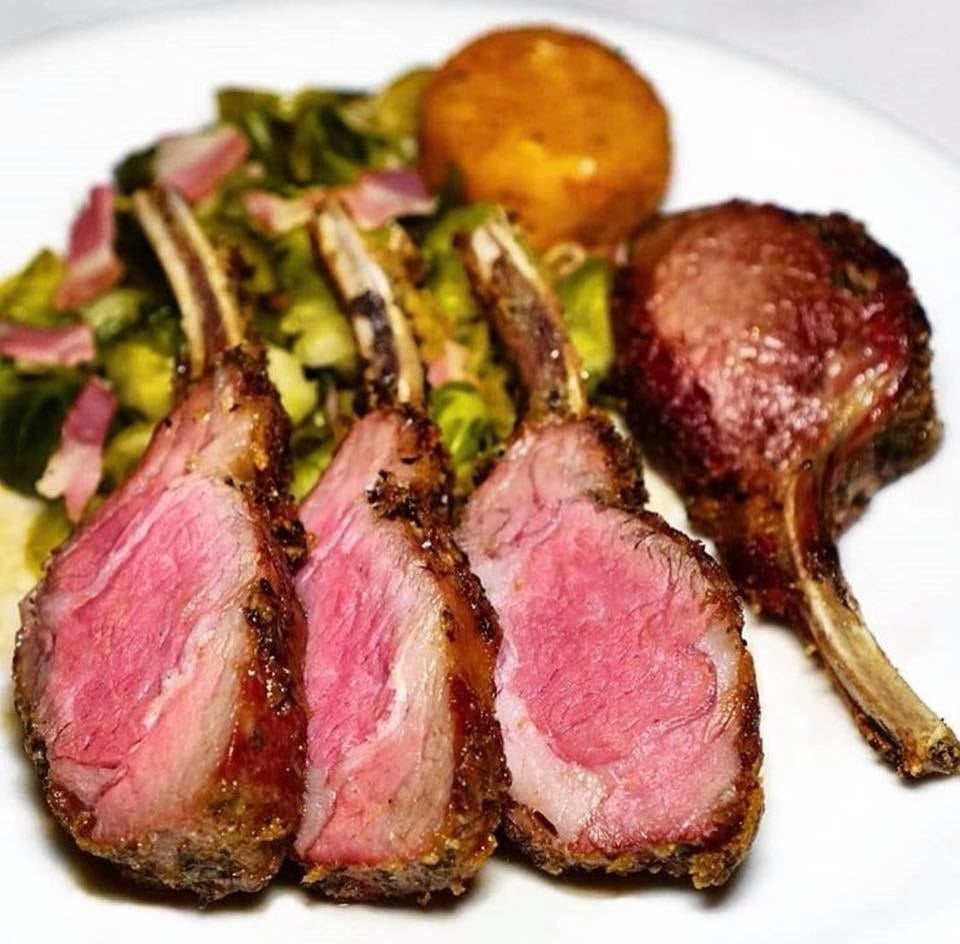 Prepared to your desired temperature, the herb-crusted Colorado rack of lamb is served with potato croquettes and Brussels sprouts sautéed with pancetta. The dish is garnished with a side of spicy fruit mustard.