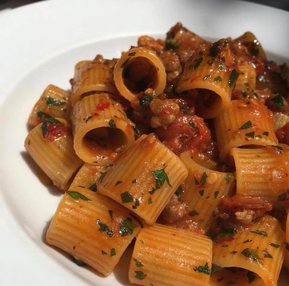 Al dente, tubular maniche pasta is prepared with spicy nduja sausage and sweet onion ragout, and scented with rosemary and a dust of parsley. The pasta evokes depth of flavors - from the hearty sausage bolognese to earthy herbs.