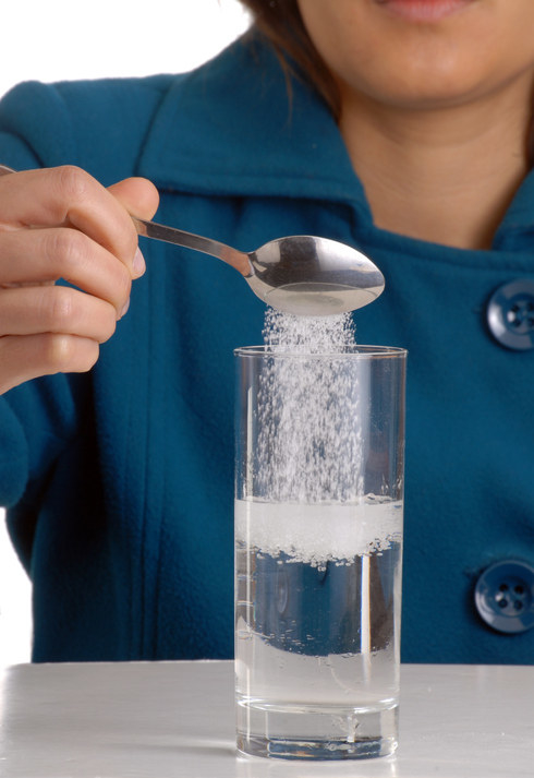 Sugar AND salt dissolved in a glass of water.