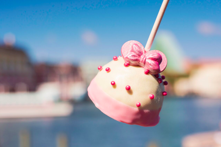 What is it: Cake pop dipped in white chocolate and topped with pink crispy pearls and millennial Minnie earsWhere to find it: Disney's BoardWalk Bakery
