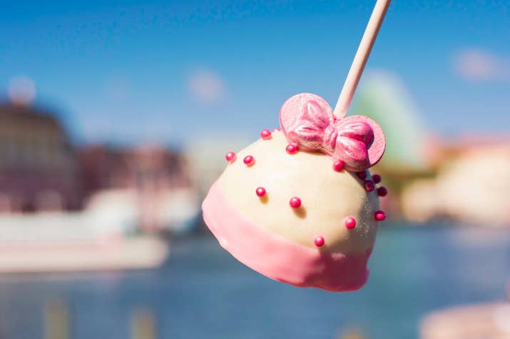 What is it: Cake pop dipped in white chocolate and topped with pink crispy pearls and millennial Minnie earsWhere to find it: Disney&#x27;s BoardWalk Bakery