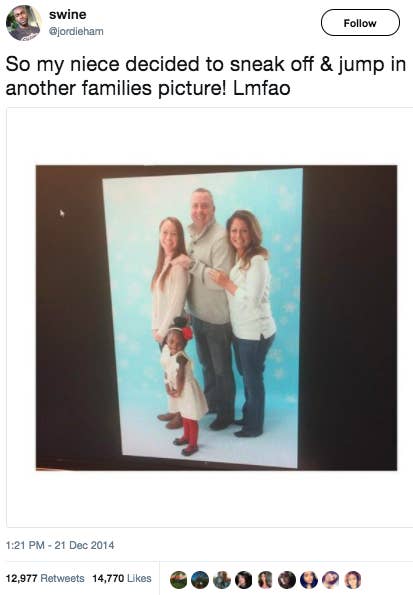 Smiling little Black girl in a picture with three smiling white adults