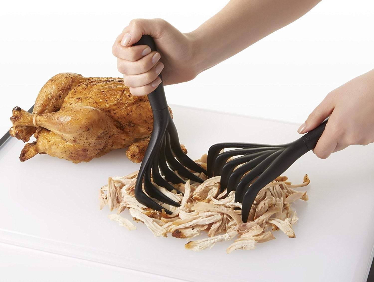 Model using the claws to shred some rotisserie chicken