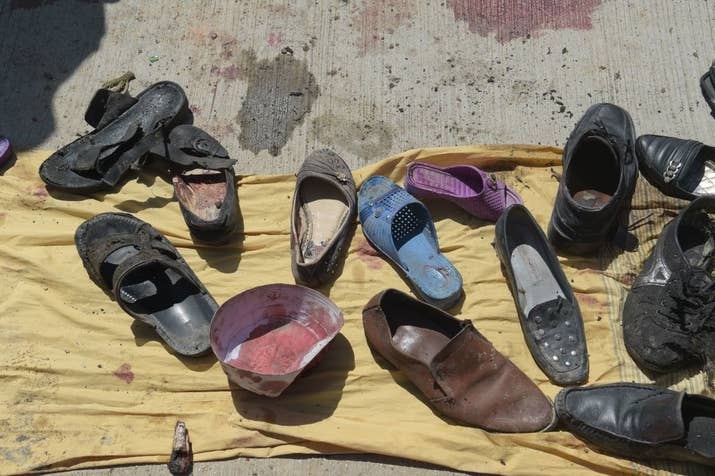 Abandoned shoes belonging to victims of a suicide bombing at the scene of the attack outside a voter registration center in Kabul, Afghanistan, on April 22, 2018.