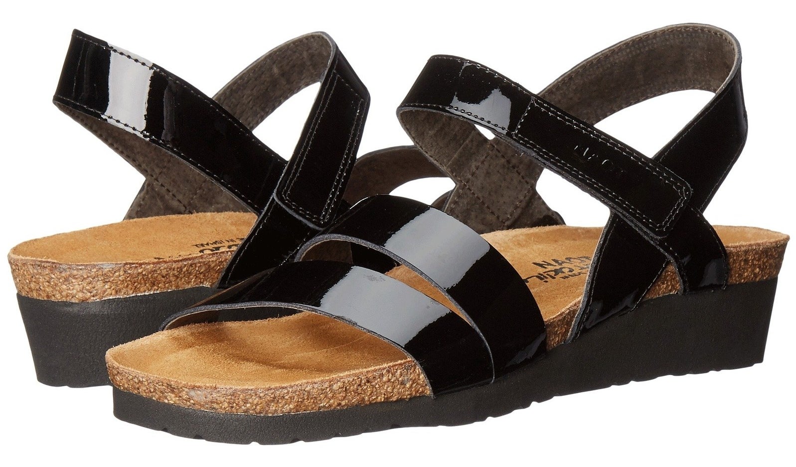A pair of the Naot adjustable leather sandals in black patent. 