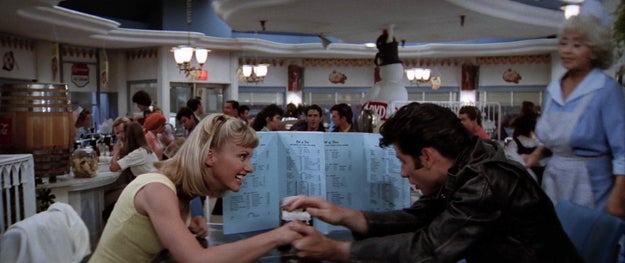 Lucky for him, it somehow works! Sandy immediately takes him back, and the first thing he does is try and hide her from his friends at the diner. Classy!