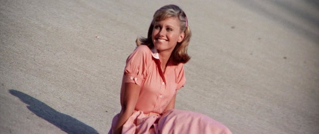 Sandy watches Danny from afar during the car race, and decides she's still in love with him — for reasons that are COMPLETELY UNFATHOMABLE TO ME! And she comes to the conclusion that the only way Danny will accept her is if she completely changes herself.