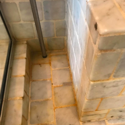 The tile with the grime starting to fade, with the text 