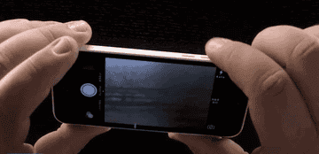 Person using the volume to take a photo on a phone