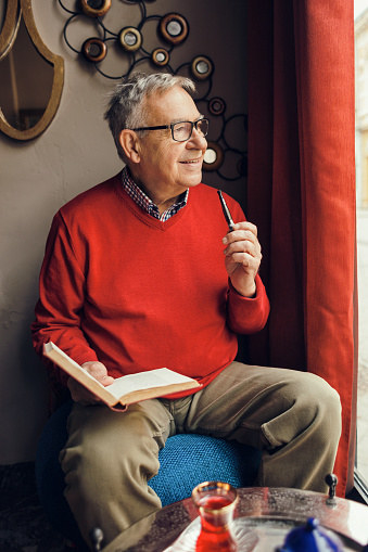 An old man reading a book.