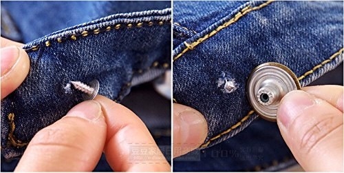 person placing a jean button onto a pair of jeans