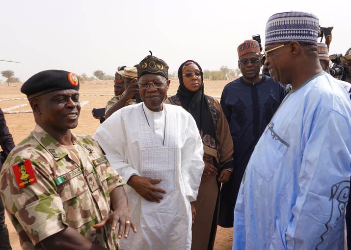 Yobe State Governor Ibrahim Gidan (right) speaks with Information Minister Lai Mohammed and the head of the military force fighting Boko Haram, Major General Rogers Nicholas, on the premises of the school after the girls were abducted.