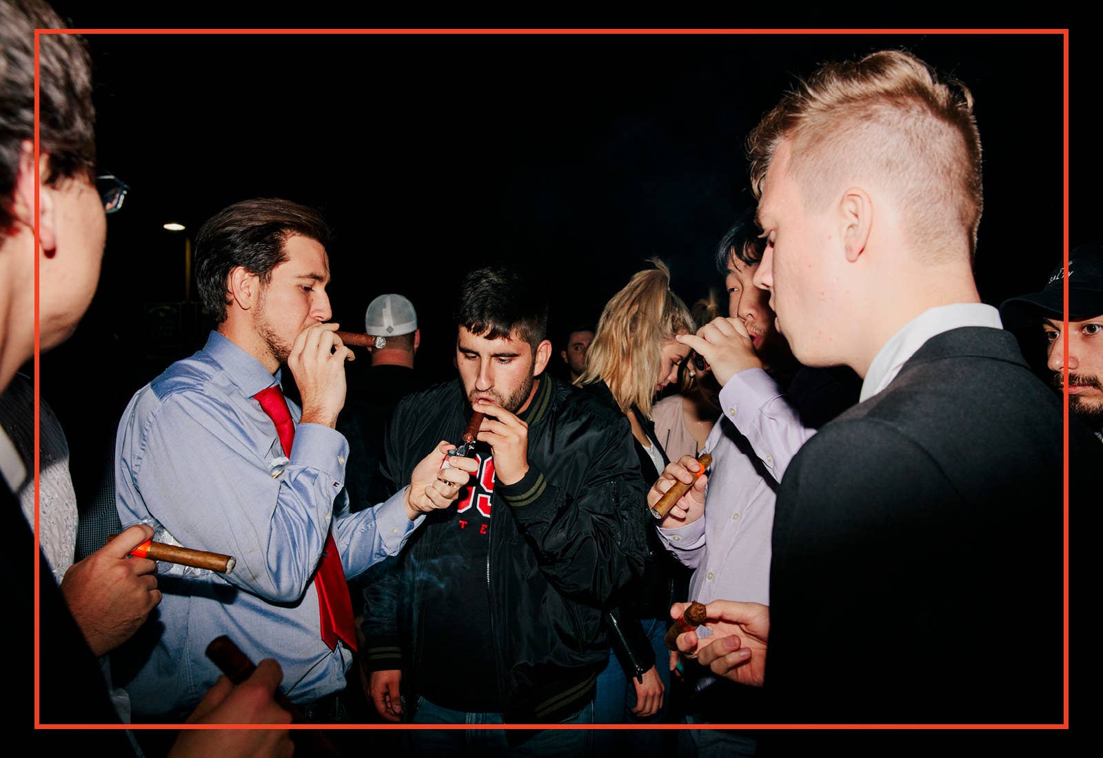 Members of the California College Republicans light and smoke cigars at the cigar social event on the first night of the three-day convention in Santa Barbara, California on April 6, 2018.