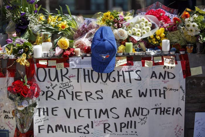 Tributes are seen on a memorial at Yonge Street and Finch Avenue in Toronto.
