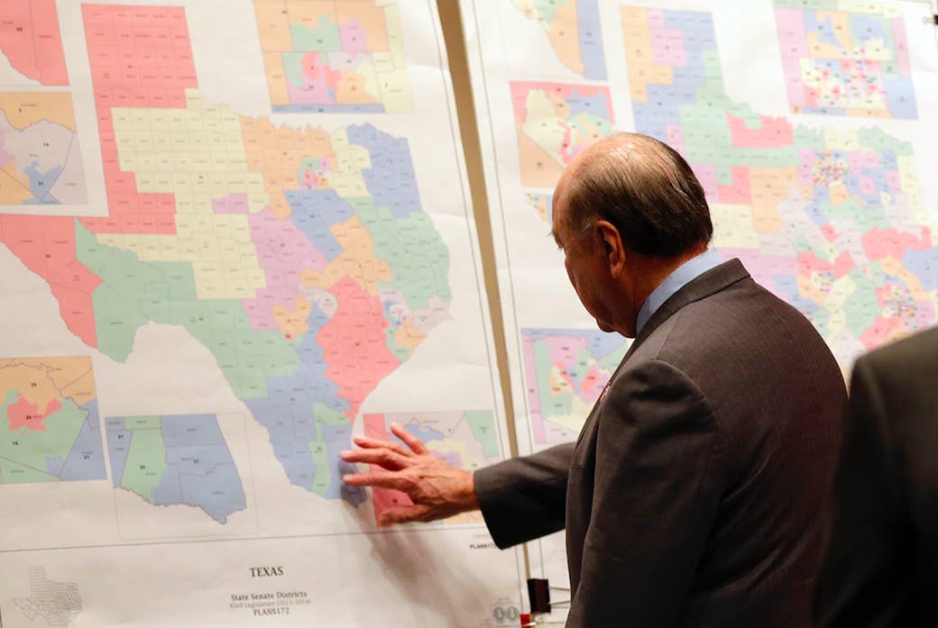 Texas State Sen. Juan &quot;Chuy&quot; Hinojosa looks at legislative district maps prior to a Senate Redistricting committee hearing in May 2013.