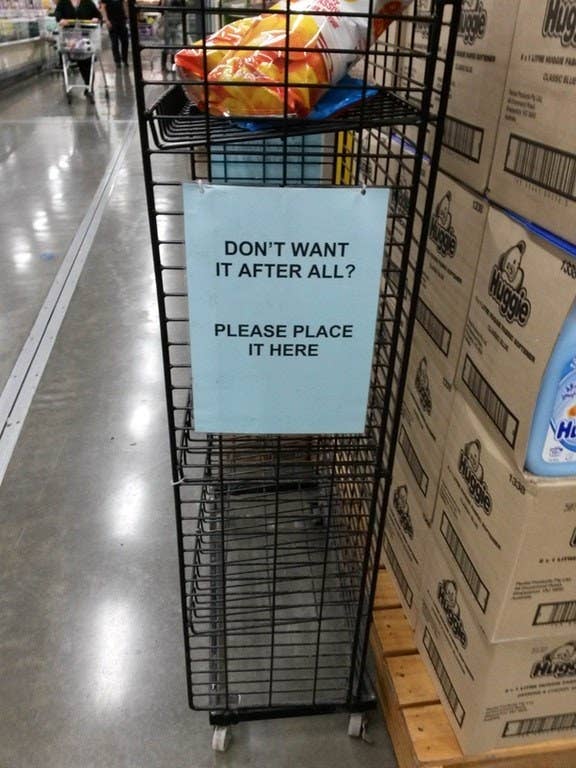 A shelf with a sign that reads: Don&#x27;t want it after all? Please place it here