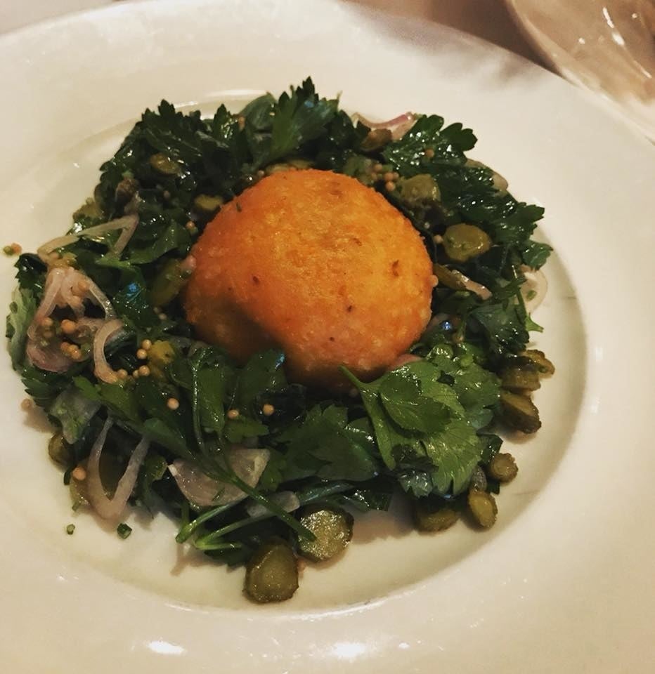 A small fist-sized malakoff, or ball of fried cheese with perfectly crispy edges, are complemented by parsley and cornichons salad.