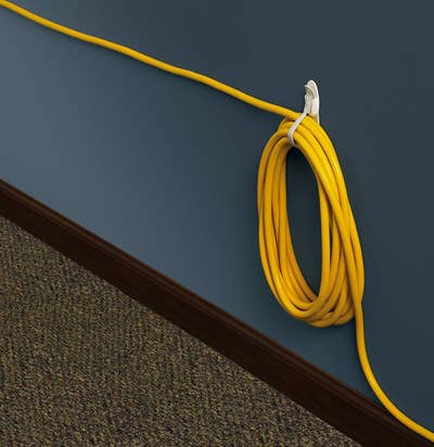 wound up cord hanging from hook on wall