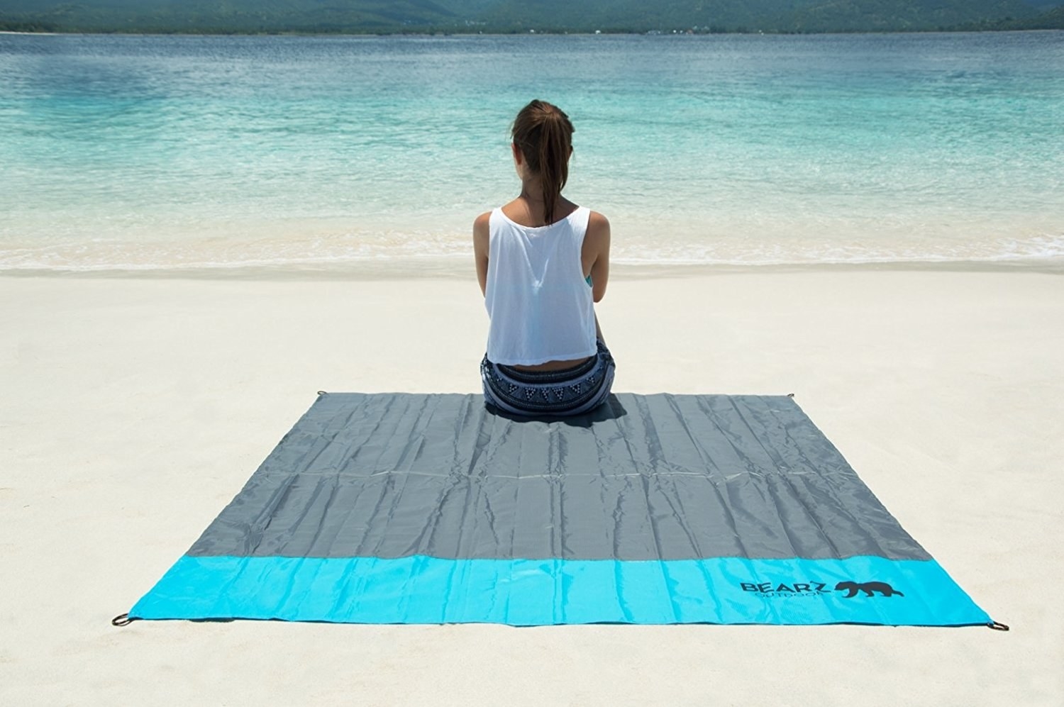 person sitting on blanket