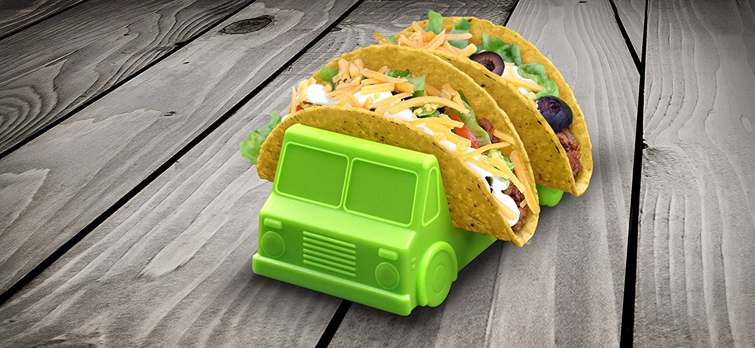 Promising review: "These little taco truck holders are not only adorable, they actually work REALLY well! They held the taco shells well and the tacos didn't try to fall in either direction. We actually placed the shell right on the truck and made our tacos that way — it worked out nicely! If you don't already own two of these, you should get some. You won't regret the purchase!" —NickyGet a set of two from Amazon for $13.95.