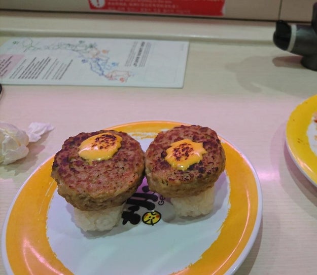 This plate of cheeseburger nigiri with a questionable yellow sauce.