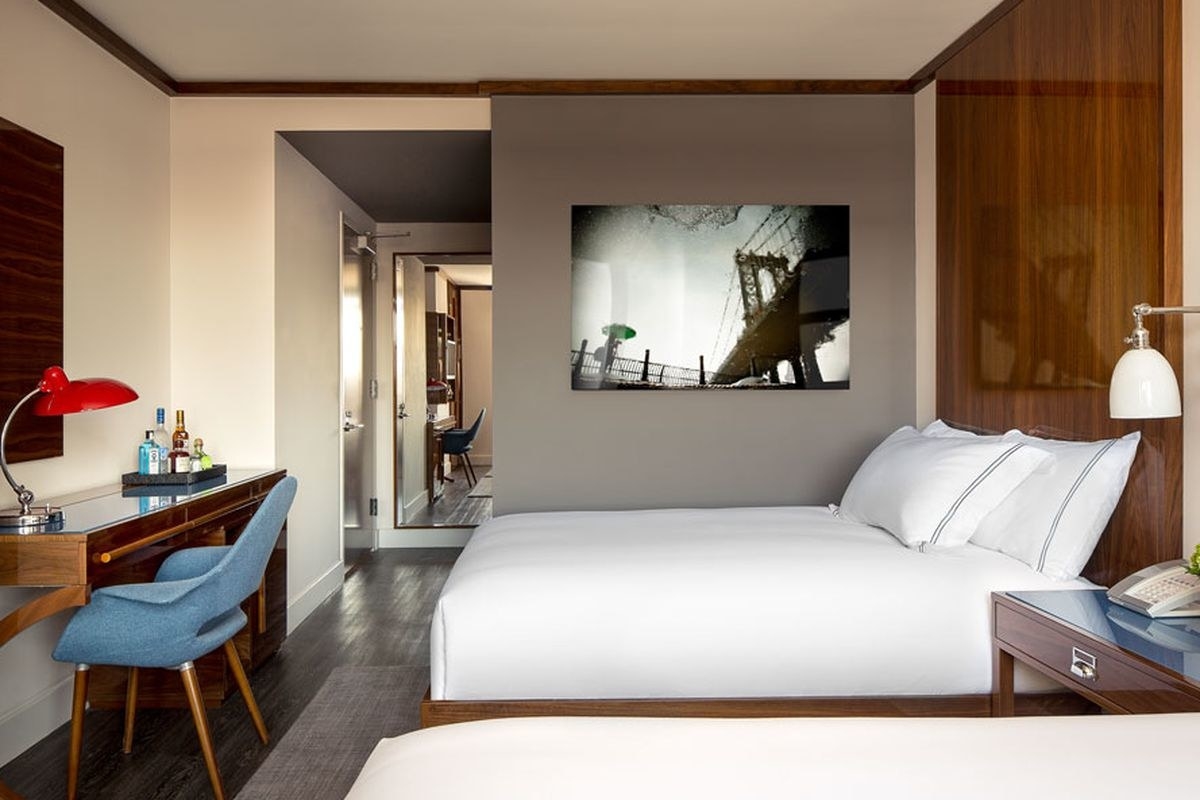 There are 122 guest rooms and suites that exude a bygone era of industrial style. Each room features plush, comfortable beds with rustic yet modern custom wood furnishings and retro industrial chic light fixtures. Guests feel right at home with modern amenities like spacious workspace, 32'' flat screen TV, and fitness studio, as well as luxurious bathrooms decorated with custom Italian tile work and featuring rain showers and rich terry robes.