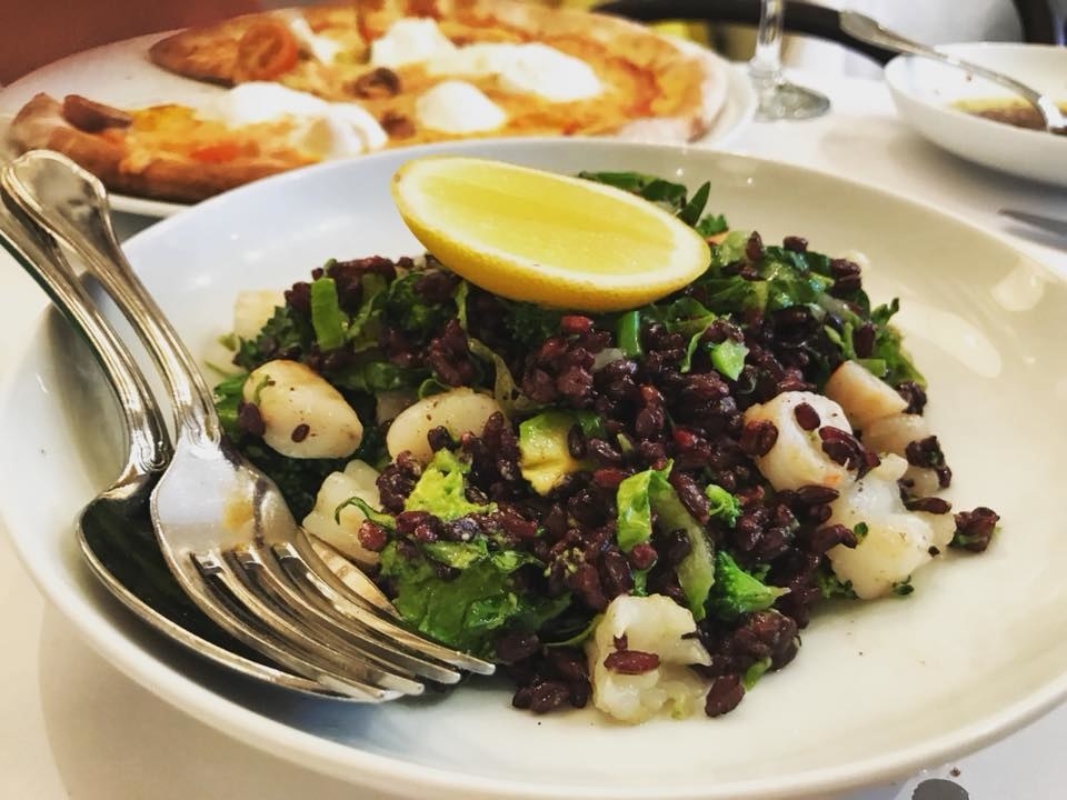 Al dente Italian black rice is mixed in with plump shrimps, broccoli, avocado, and lettuce with a wedge of lime to create this refreshing, healthy salad.