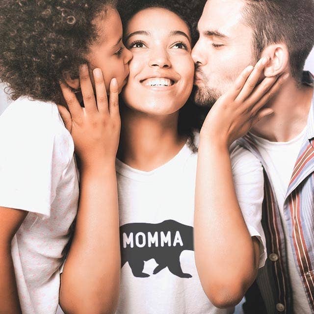 Model wears a shirt with &quot;MOMMA&quot; overtop of a bear silhouette 