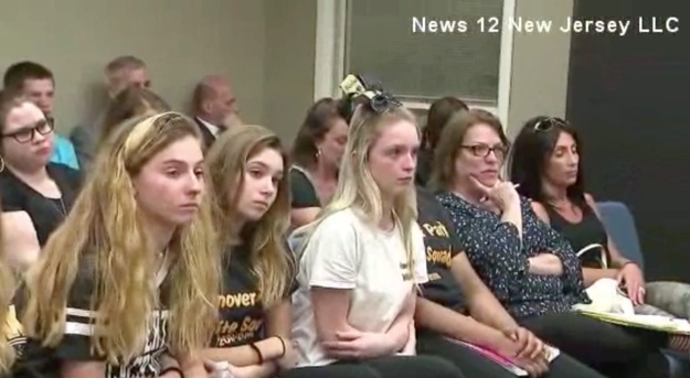 The decision has pissed off many current cheerleaders and their parents — especially those who've been training rigorously to make the elite top team. Last week, a group of them showed up at a school board meeting to push back.