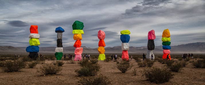 This is an art installation by Swiss artist Ugo Rondinone, and the piece is located about 10 miles outside of Las Vegas. The exhibition was originally scheduled for two years, but due to popular demand, Rondinone is exploring ways to keep the artwork on view at its current site.