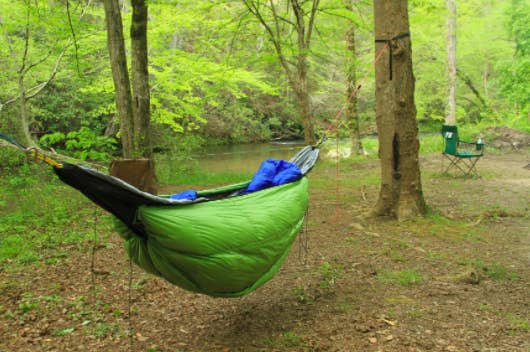 the hammock sleeping bag hanging from two trees