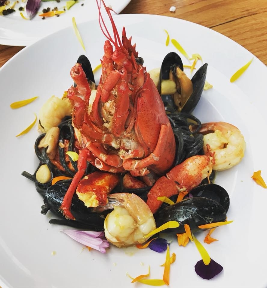 As delicious as its presentation, the Lobster Fumet features a whole lobster with various seafood like mussels, shrimp, scallop, white fish, and octopus over black linguini, all mixed in creamy saffron sauce.