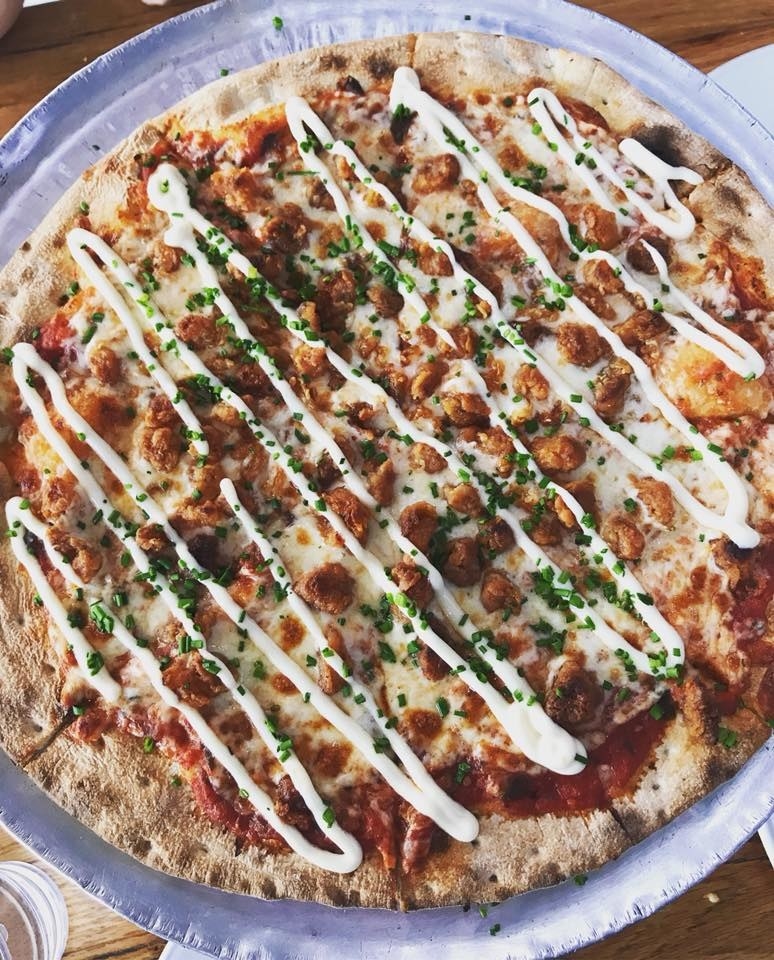 Yes, you read that right and it's not a typo! The Alligator Pizza, indeed, features popcorn alligator (think of it as crispier, almost bacon-like version of popcorn chicken) with white cheddar and crushed tomato with a drizzle of lemon aioli and chives.
