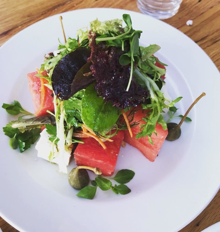 A perfect menu for the summer, the salad features cubes of quenching watermelon and blocks of feta with mixed greens, basil, caper berries, and mint, all tossed in mint jalapeño vinaigrette.