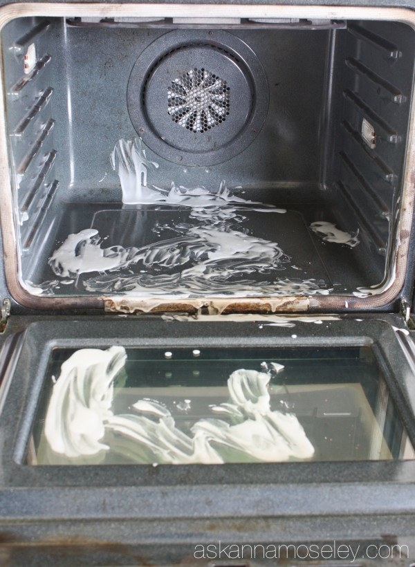 An oven with white paste smeared on in several spots