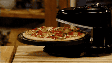 pizza rotates with heat light over it 