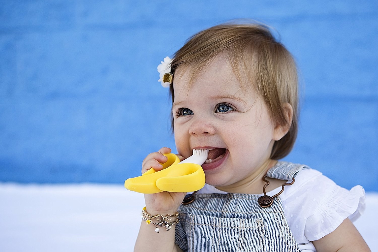 Promising review: "My baby LOVES this teether!! I bought it for him when he was three months old. It was hard for him to hold things since he was just starting to grab. This banana teether was very easy for him to grasp and put in his own mouth. The grip is great, it's very ergonomic for a baby and I love the feel of the silicone. Other teethers he would only use for a minute or so and get fussy or frustrated, but this teether can keep him occupied for awhile!" —MelissaAges: 3 months +Price: $7.61 (available in four colors and seven total designs)
