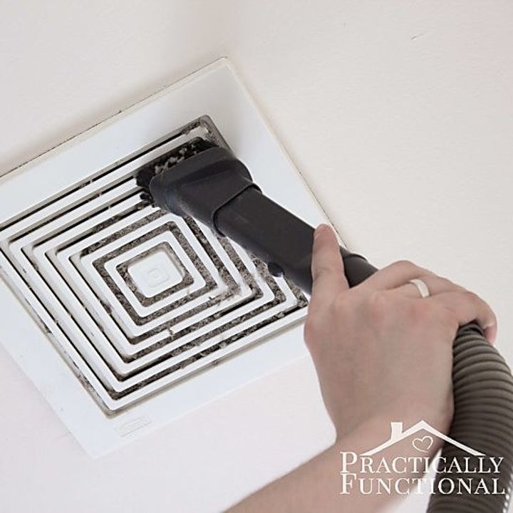 blogger vacuuming outside of fan