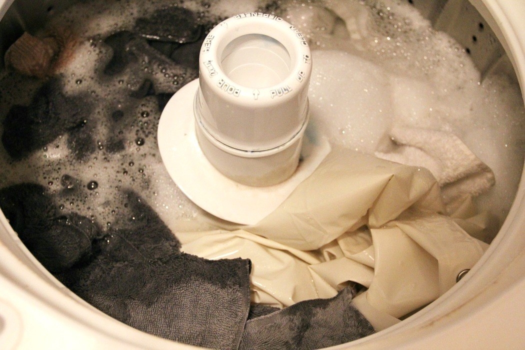 A blogger&#x27;s towels and shower curtain liner in their washing machine