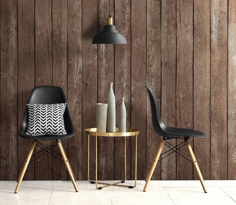 Promising review: "Love these mid-century modern chairs! Easy to put together and perfect with an accent pillow (also a Walmart find). These will not disappoint anyone wanting to achieve this look and add style to their home! —MamaburgPrice: .23+ (for a set of two; available in four colors)
