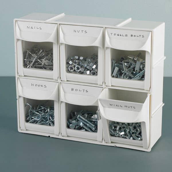 Two rows of three flip-out bins in white filled with nails, bolts, hooks, and other small tools