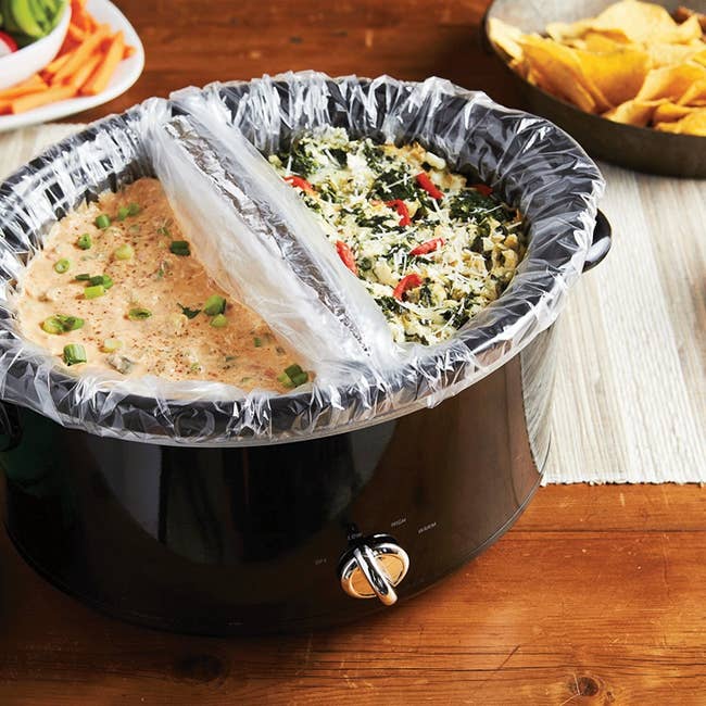 slow cooker with plastic liners creating two sections for two different kinds of dip 