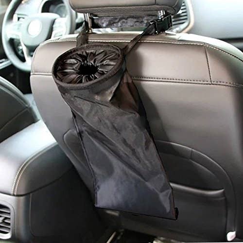 back of a car front passenger seat with a bag-like trash bag attached to it 