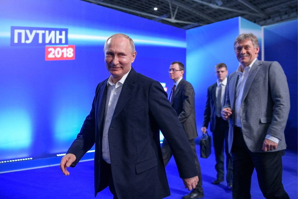 Putin and his spokesman Dmitry Peskov (right).