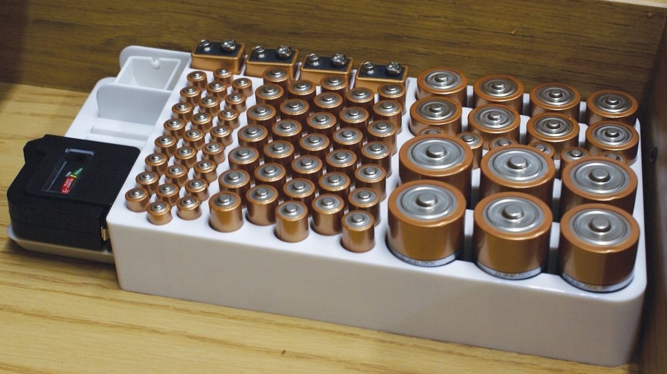 The battery organizer filled with all different sizes of batteries