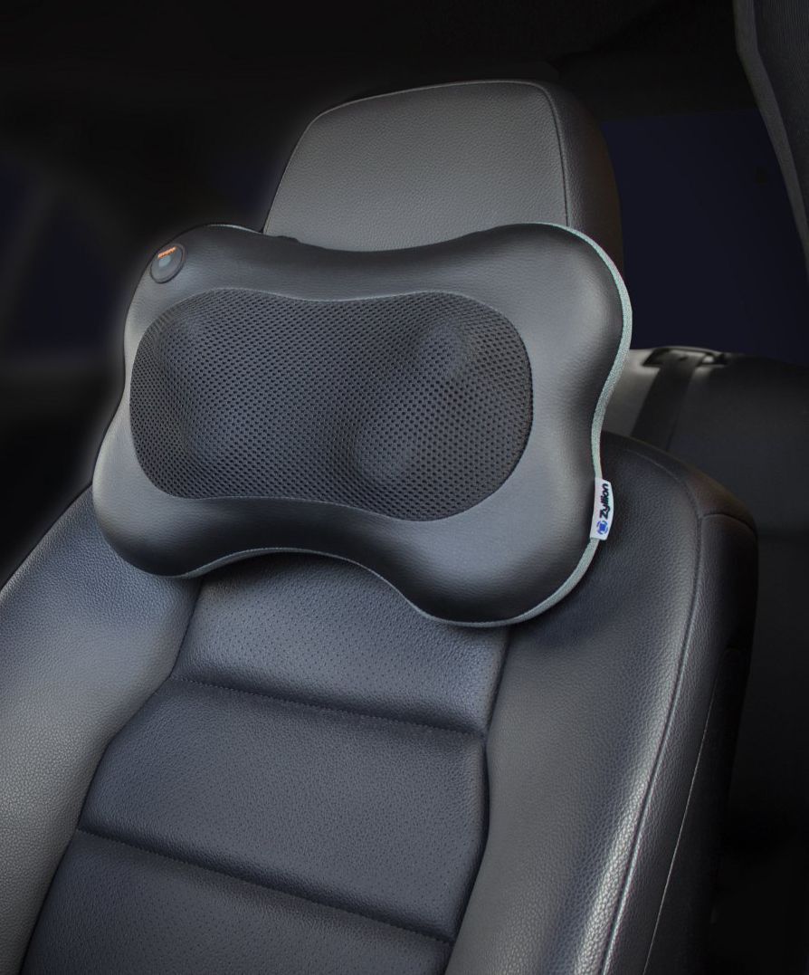 the neck massager attached to the headrest of a drivers side car seat