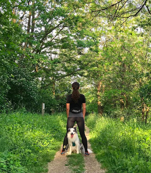 A woman walking her dog outside.