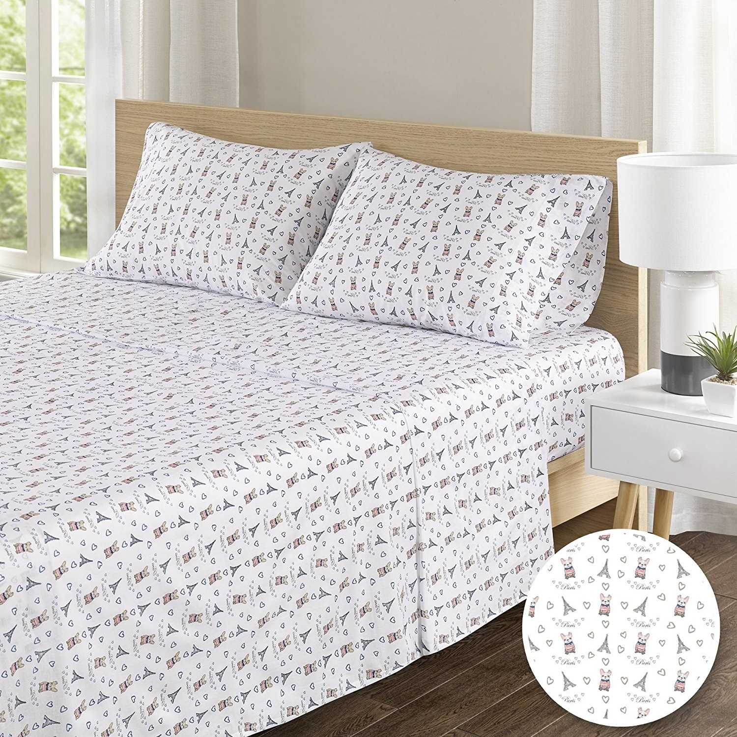The sheets on a full-size bed in the French bulldog print.